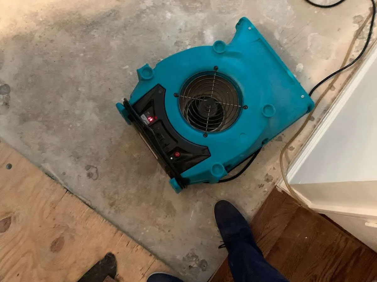 Air mover drying subfloor during Commercial Water Damage Restoration in Kendallville